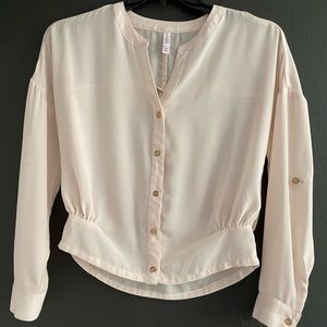 Blouse with gold tone buttons.